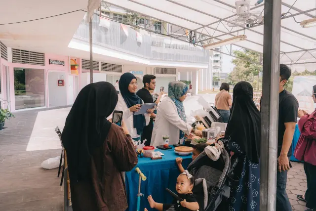 Families ordering at the Brewprint stall while the team takes orders on a tablet