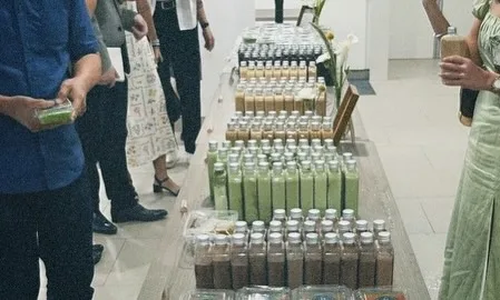 Wedding guests collecting bottled matcha and coffee door gifts from the table